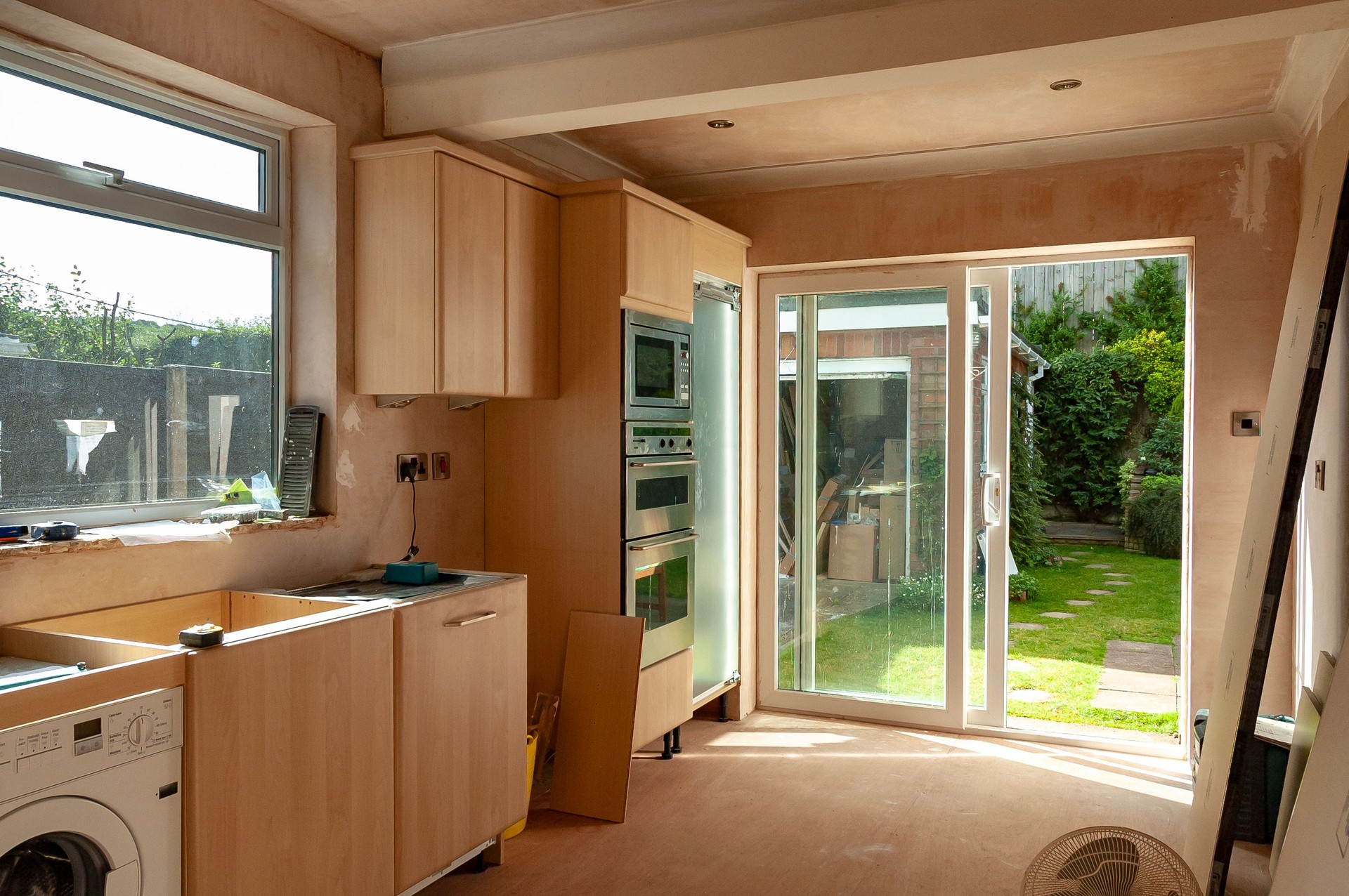 Partially fitted kitchen in a domestic home with cabinets and appliances installed but awaiting completion.